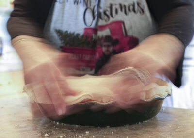 Moving hands sealing pie crust.