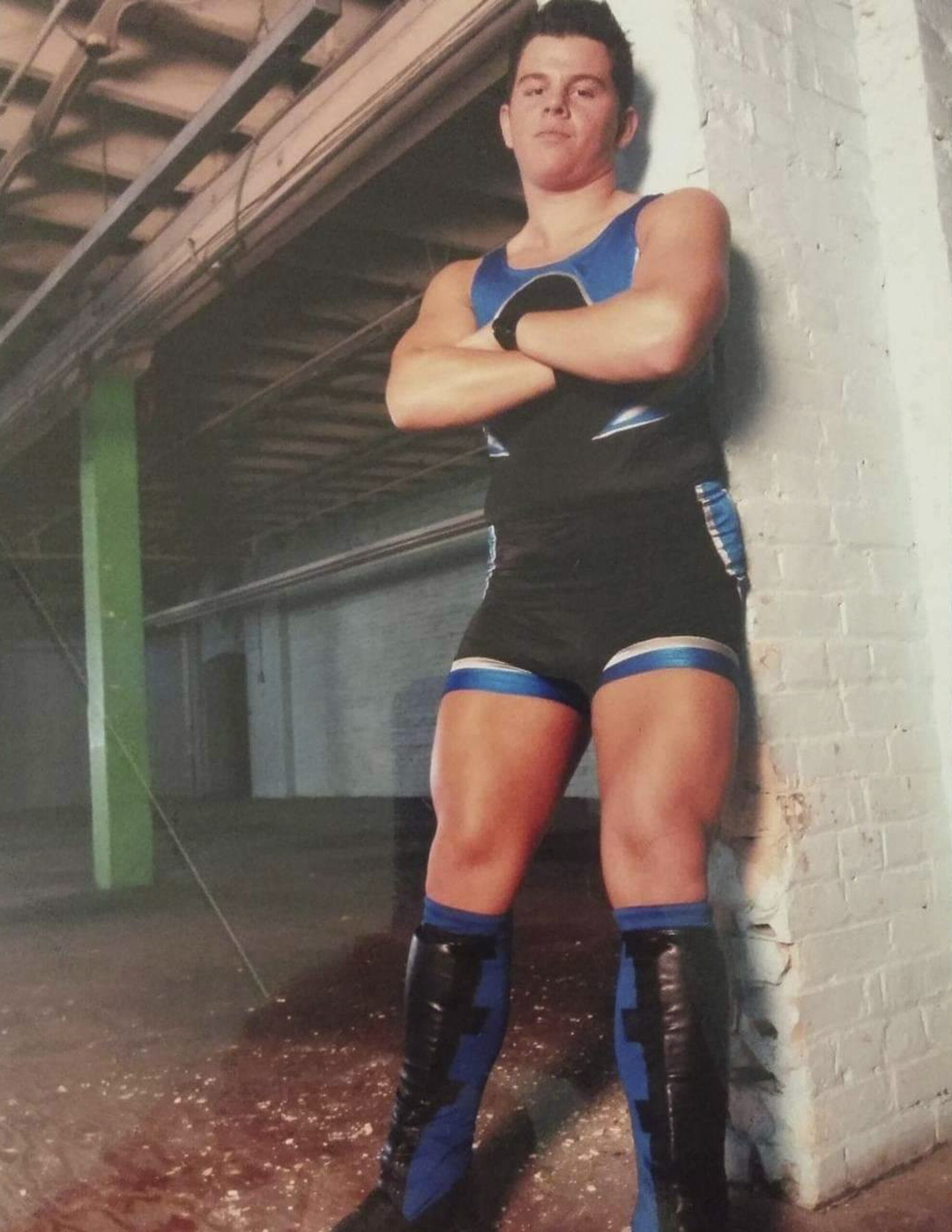 Professional wrestler Stefan Richard stands up against a brick wall for a promotional photo.
